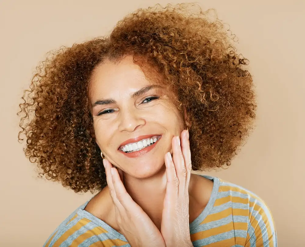 happy woman smiling at the camera after a facelift